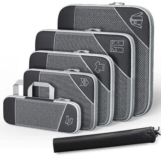 Set of gray packing cubes with a rolled black mat on a white background