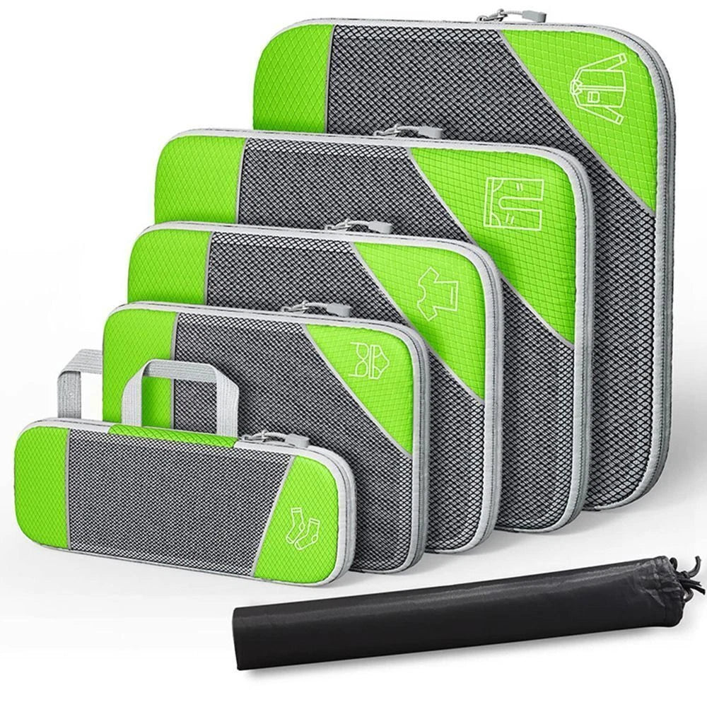 Set of green and gray packing cubes with a black compression bag on a white background