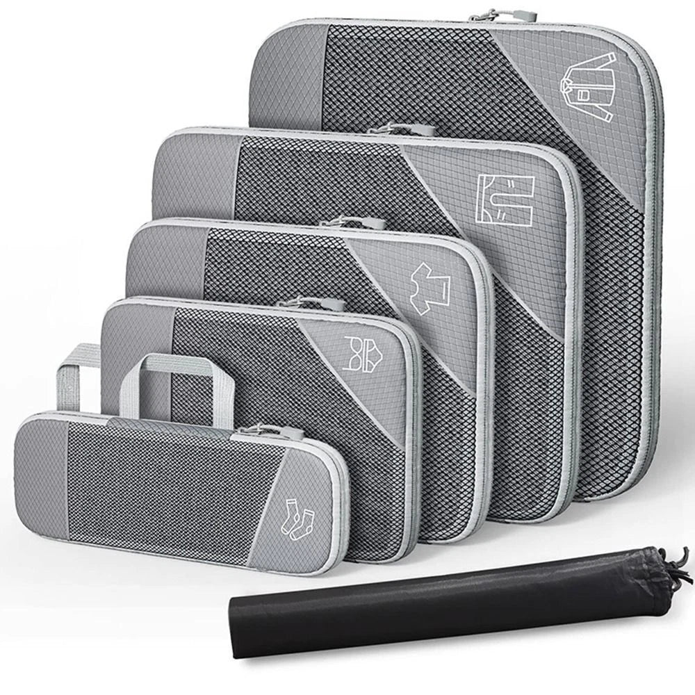 Set of gray packing cubes with a rolled black mat on a white background