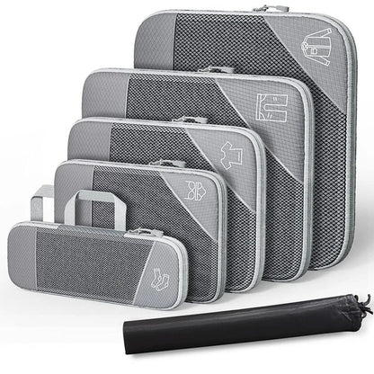 Set of gray packing cubes with a rolled black mat on a white background